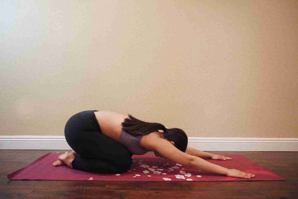 girl doing yoga child's pose